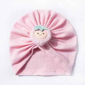 Pink waffle knit baby turban hat with a cute embroidered strawberry pompom detail