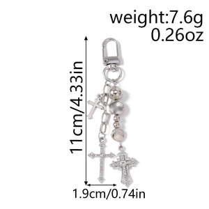 Detail showing beaded silver keychain with rhinestone crosses and metal lobster clasp