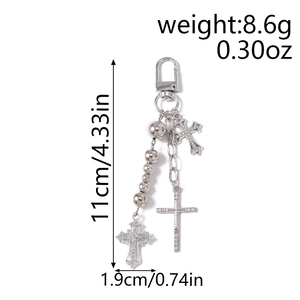 Detail view of silver beaded keychain with rhinestone cross charms and metal hook