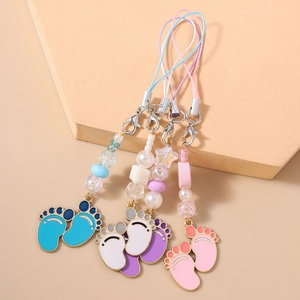 Three colorful enamel baby footprint charms with beads and lanyards for bags and phones