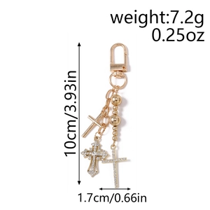 Detail showing dimensions and weight of the gold beaded cross keychain for bags