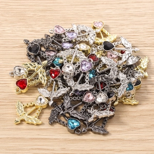 Macro shot of colorful heart arrow charms with cubic zirconia for DIY jewelry making