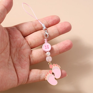 Detailed view of handmade pink beaded phone strap with paw pendants and woven cord