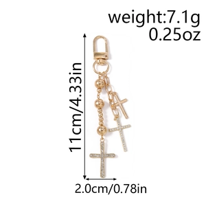 Detail of gold beaded keychain with rhinestone cross charm and sizing measurements