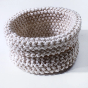 Detailed macro view of the cream-colored pearl knit texture on this warm baby neck warmer