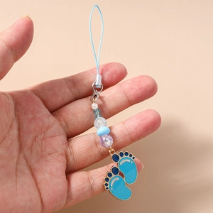 Detail of blue enamel footprint charms and pearl beads on a handmade phone strap