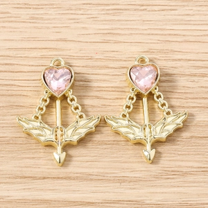 Detail of pink heart pendants with cupid arrow and golden wings for jewelry making