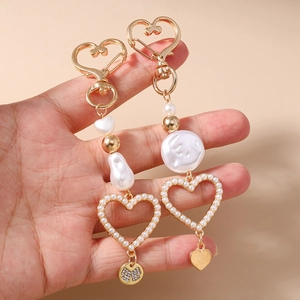Irregular pearl heart keychain with gold bow and heart-shaped lobster clasp detail
