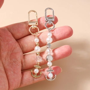 Porte-clés ancre élégant avec perles blanches et ornements en métal doré et argent