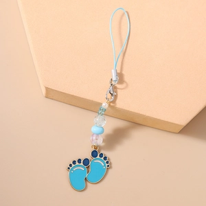 Close-up of blue enamel footprint charms with light blue beads on a phone strap hanger