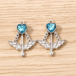 Close-up of heart-shaped arrow charms with light blue crystal inlay and silver alloy finish
