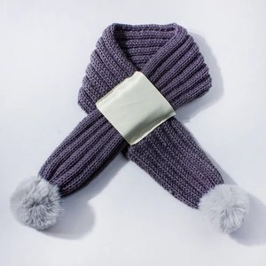 Close-up of purple knit scarf with thick ribbed texture and gray faux fur pom-poms