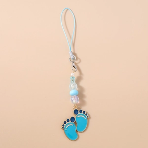 Detailed close-up of blue enamel baby footprints pendant with pearls on a phone strap