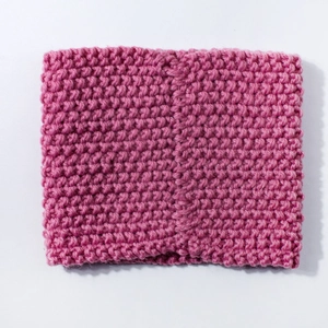 Close-up of rose pink ribbed knit baby neck warmer with textured wool stitching