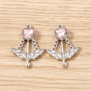 Detailed view of pink heart crystal pendants with silver wings and Cupid arrow design
