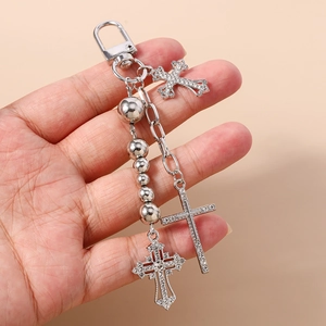 Detailed view of silver beaded keychain with sparkling rhinestone cross pendants and metal chain