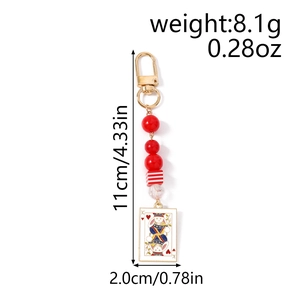 Detail of beaded keychain with red beads and white rabbit poker card pendant charm