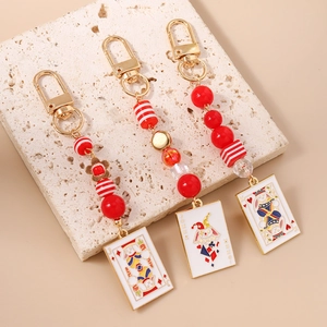 Poker themed keychain set with red beads and enamel playing card charms in golden finish