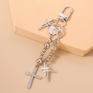 Detail view of silver beaded keychain with rhinestone cross and infinity symbol charm