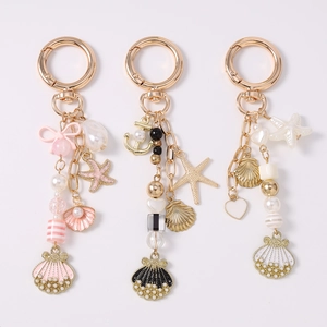 Nautical style keychain with pearls, sea shell and starfish charms in pink black and white