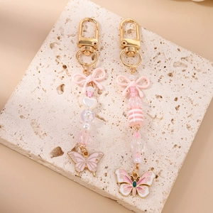 Set di portachiavi con perline rosa e oro con ciondoli a farfalla e chiusura a moschettone