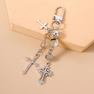 Detail of silver-toned beaded keychain with sparkling rhinestone cross pendants and metal balls