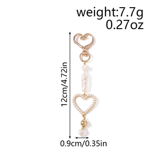 Detailed size view of heart pearl keychain with gold metal buckle and length measurements
