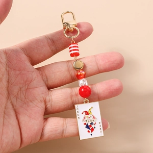 Detail of beaded Joker playing card keychain featuring colorful beads and gold clasp