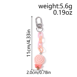 Detailed view of pink swirl lollipop keychain with acrylic links and metal clip