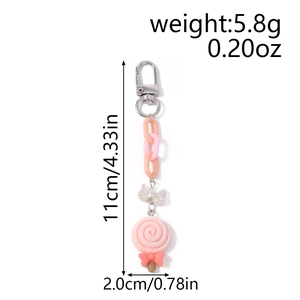 Detailed view of pink lollipop keychain with metal lobster clasp and dimensions