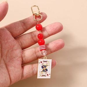 Detail of playing card rabbit charm with red beads and golden lobster clasp