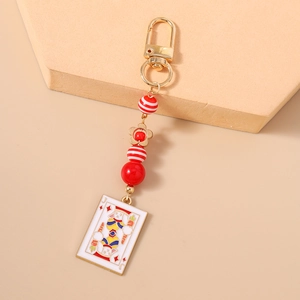 Detail of bunny poker card J charm and red striped beads on a gold keychain