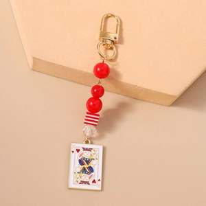 Detail of creative rabbit poker card keychain with red beads and golden clasp finish