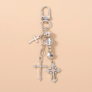Detail of silver beaded keychain with rhinestone cross charms and metal ball accents