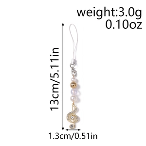 Detailed view of G-clef pendant with pearls and rhinestones showing 13cm length