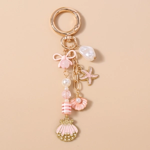 Detail of nautical keychain with gold clasp, pink starfish, shells and pearls