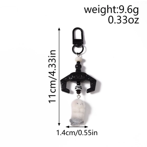 Detailed view of plush cat charm with dimensions and weight for bag accessories