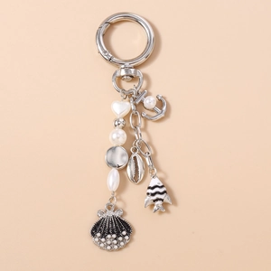 Detailed nautical keychain with pearl heart, black enamel shell, anchor, and conch charms