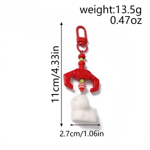 Mechanical claw keychain with white plush dog pendant and size measurements detail