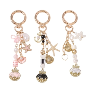 Ocean themed keychains with pearls shells and starfish charms in pink gold and white