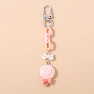 Close-up of pink lollipop keychain with metal lobster clasp and decorative plastic chain