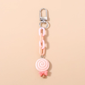 Detailed view of pink swirl lollipop keychain with resin charm and colorful plastic links