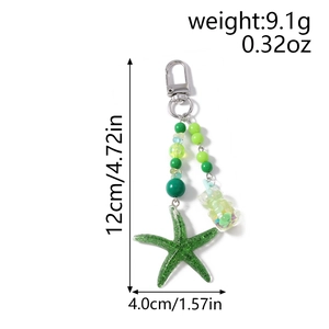 Porte-clés étoile de mer pailleté vert avec breloque bouteille et dimensions 12x4cm