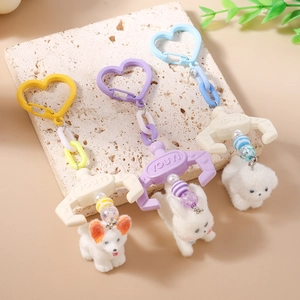 Three plush puppy keychains with heart-shaped clips and creative claw machine hooks