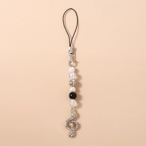 Detail of beaded phone strap with pearl beads and rhinestone treble clef music pendant