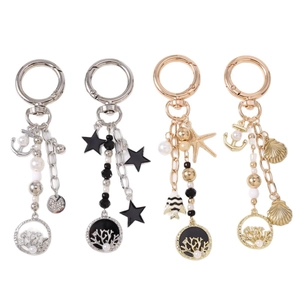 Porte-clés étoile de mer et ancre dorés et argentés avec perles et anneaux de corail