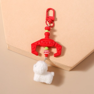 Detail of red claw hook and white plush puppy charm keychain with colorful beads