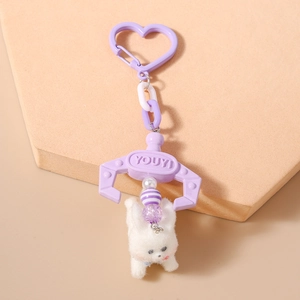 Detailed close-up of a lavender plush bunny keychain with heart hook and claw charm