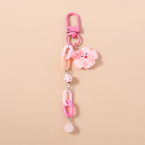 Détail d'une chaîne de téléphone rose avec maillons épais et breloque nuage mignonne