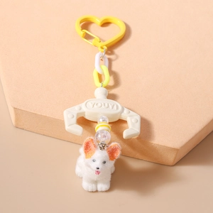 Detail of creative dog keychain with heart clip and orange mechanical claw accessory